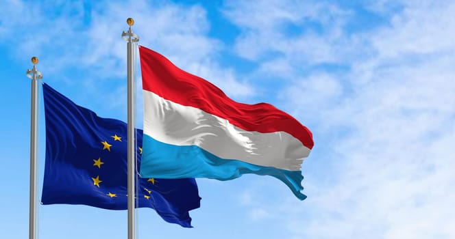The flags of Luxembourg and the European Union waving in the wind on a clear day. Luxembourg became a member of the EU in January 1958. 3d illustration render. Fluttering textile