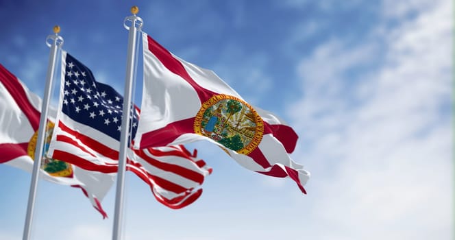 The flags of Florida and United States waving in the wind on a clear day. Florida is a state in the southeastern US. US federate state. 3d illustration render. Selective focus. Fluttering textile