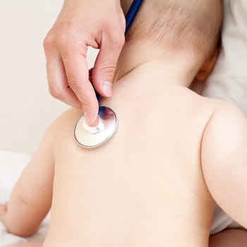 Children's doctor exams infant with stethoscope