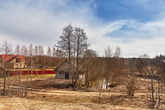 Ruins of old water mill at springtime. March spring day. Calm weather. Season change. Village rural landscape. Belarus.