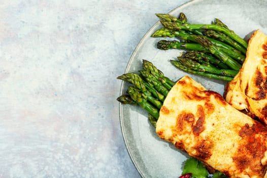 Delicious egg omelet cooked with green asparagus. Space for text