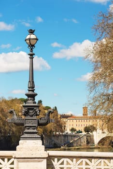 Rome. Ponte Mazzini, over Tiber river. The bottom of the lights on the bridge show beautiful ironwork.
