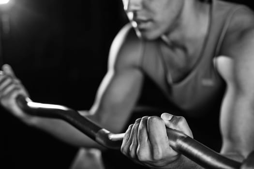 Young man lifting heavy metal weight
