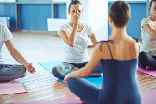 Young woman repeating yoga exercise after trainer