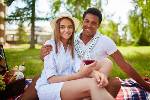 Happy dates enjoying picnic in park