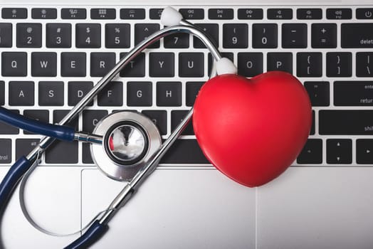 Doctor Day Concept, Top view health doctor stethoscope and red heart on keyboard of laptop computer with copy space, care patient in hospital, Medical and Healthcare insurance, RX prescription