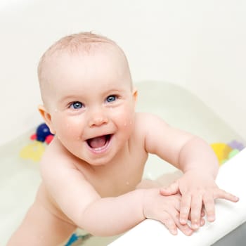 Happy bathing little baby girl