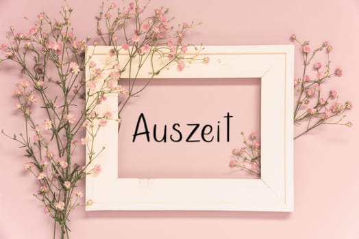 Vintage Photo Frame With Ikebana Flower Arrangement With German Text Auszeit Means Downtime. Retro Pastel Background