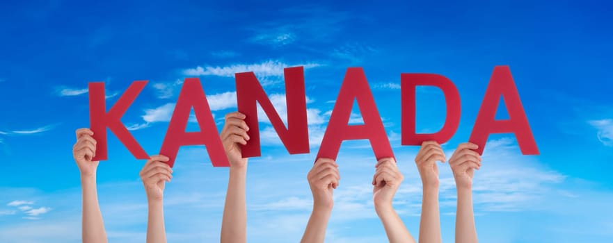 People Or Persons Hands Building German Word Kanada Means Canada. Blue Sky As Background.