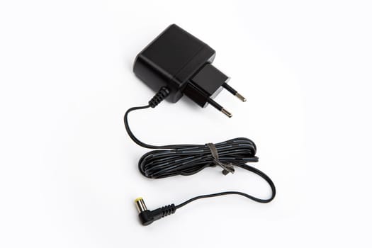 Black power supply with cable isolated on white background