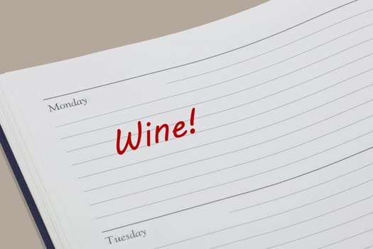 A Wine reminder note in red ink in a diary page
