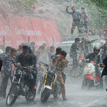 People at the Waterparty at the Thingyan Water Festival at the Myanmar New Year in the city centre of Mandalay in Manamar in Southeastasia.