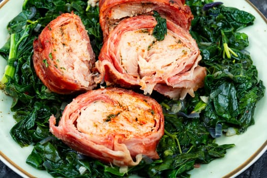 Grilled chicken fillet roll and fried spinach. Copy space