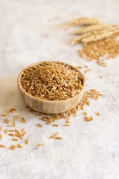 Bowl of raw dry rye grain on white table close up, copy space. Healthy alternative low gluten seeds. Protein source for vegan and vegetarian diet.
