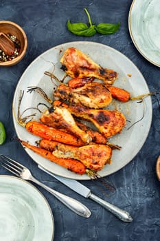 Grilled chicken drumsticks, roast chicken legs with carrots