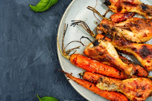 Grilled chicken drumsticks, roast chicken legs with carrots