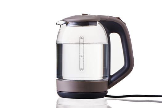 Glass electric kettle with boiling water on a white insulated background. High quality photo