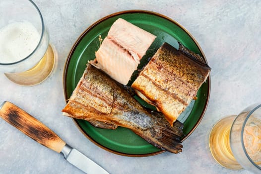 Dietary smoked trout salmon cut on a plate. Copy space