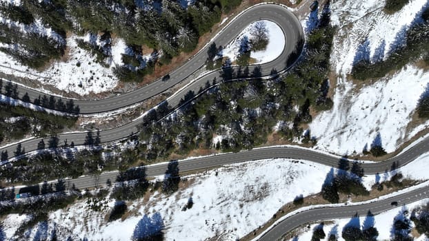 Aerial shot with drone of tight curve with cars at Gaichtpass in Tyrol