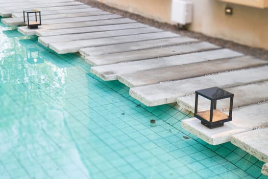 Mosaic in green transparent water at the bottom of the pool, stock photo