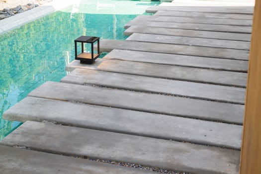 Mosaic in green transparent water at the bottom of the pool, stock photo