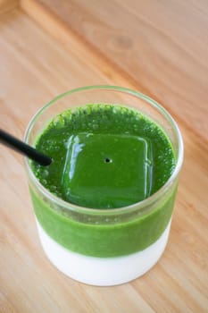 Iced matcha greentea on wooden table, stock photo