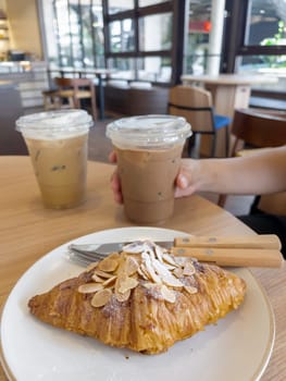 Fresh baked almond croissant and coffee breakfast, stock photo