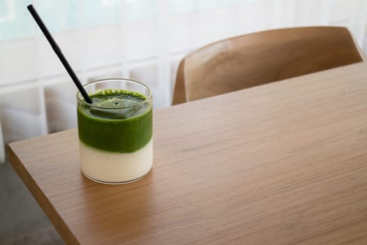 Iced matcha greentea on wooden table, stock photo