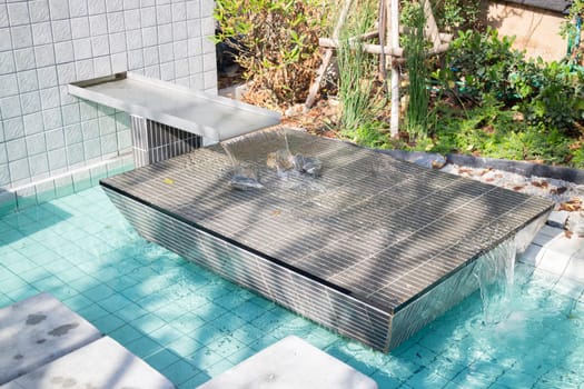 Mosaic in green transparent water at the bottom of the pool, stock photo