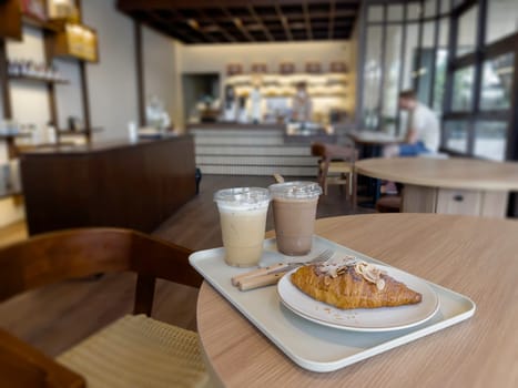 Fresh baked almond croissant and coffee breakfast, stock photo