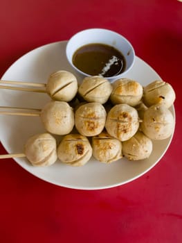 Grilled pork ball with spicy sauce Thai street food, stock photo