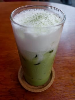 Iced matcha greentea on wooden table, stock photo