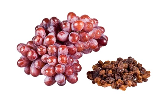Bunch of red grapes and raisins on white background
