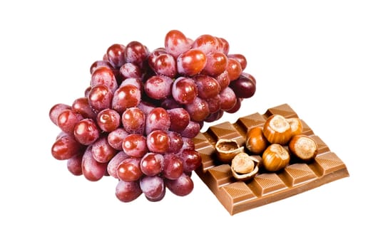 Red grapes with chocolate and nuts in shells on white background
