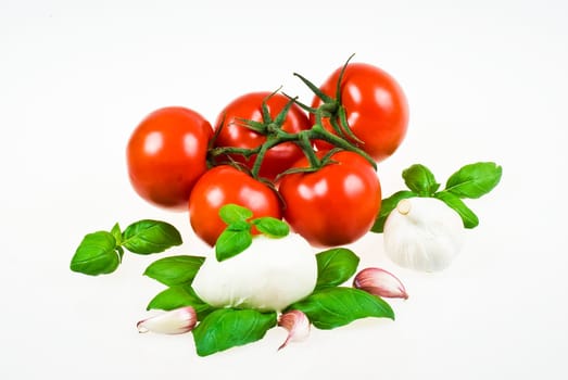 Bunch of tomatoes with mozzarella, garlic and basil