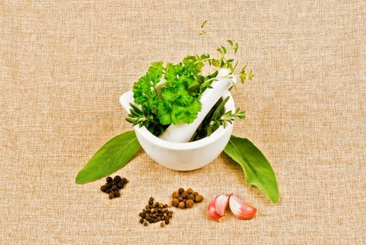 Ceramic pestle of thym, parsley, and rosemary