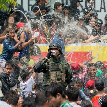 People at the Waterparty at the Thingyan Water Festival at the Myanmar New Year in the city centre of Mandalay in Manamar in Southeastasia.