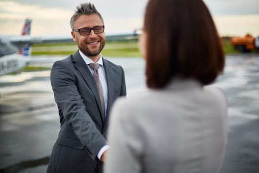 Happy businessman greeting his partner upon arrival