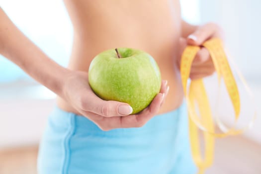 Hand of slim female with green apple