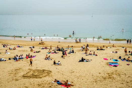 Cascais, Portugal, October 27, 2016: People are enjoying last warm days on a beach in Cascais, Portugal