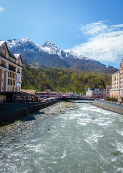 Roza Khutor, Russia, April 15, 2016: Scenic view of the town of Roza Khutor, the Mzymta River and the Caucasus Mountains, This was the site of 2014 Winter Olympic Games