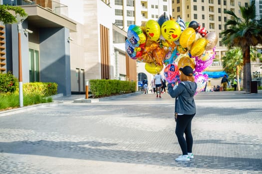 Dubai, UAE, February 23, 2018: A party balloon vendor at the Jumeirah Beach Residence (JBR) Walk - a polular destination for food, shopping and entertainment