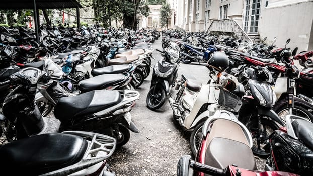 Hanoi, Vietnam, November 15., 2022: Scooter parking lot near an office building in Hanoi.