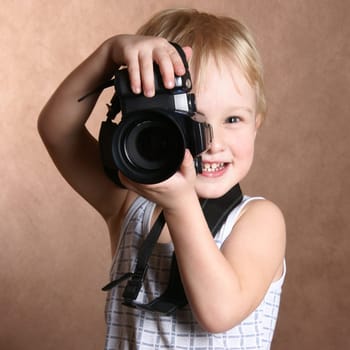 child in studio with professional camera