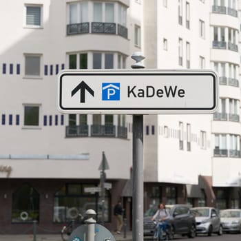 Street sign indicating a parking garage for customers of KaDeWe, Kaufhaus des Westens in Berlin. Translation: Department Store of the West