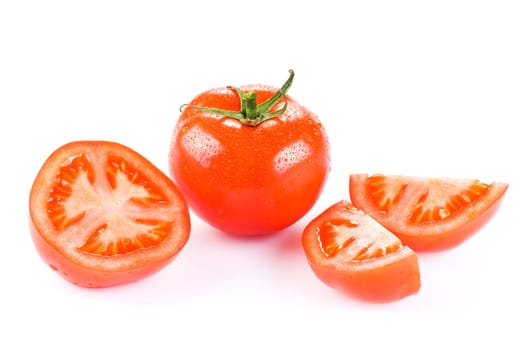 Fresh tomato with one half and two quarters over white