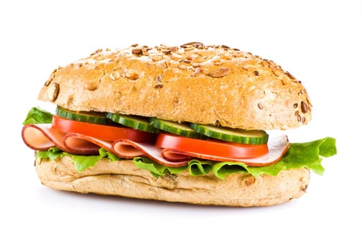 Freshly made sandwich with ham and vegetables over white