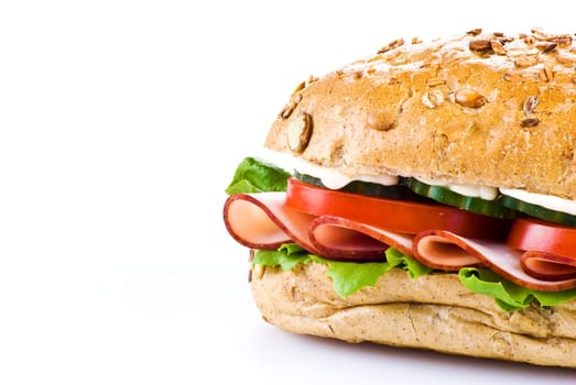 Freshly made sandwich with ham and vegetables over white