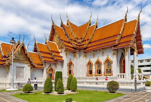 Bangkok, Thailand - Dec 4, 2022 : Tourists visiting Wat Benchamabophit Dusitvanaram (also known as the Marble Temple), a major destination in Bangkok. It shows that Thailand now welcomes tourists.