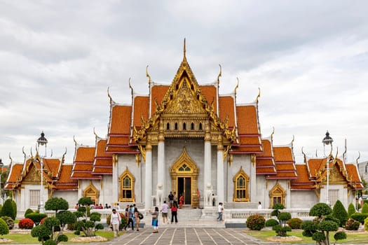 Bangkok, Thailand - Dec 4, 2022 : Tourists visiting Wat Benchamabophit Dusitvanaram (also known as the Marble Temple), a major destination in Bangkok. It shows that Thailand now welcomes tourists.